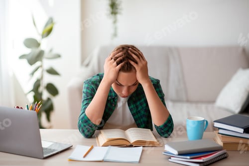 Preview: Tired schooler studying at home, getting ready before exams