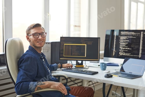 Preview: Portrait of IT Programmer Using Computers with Code on Screen