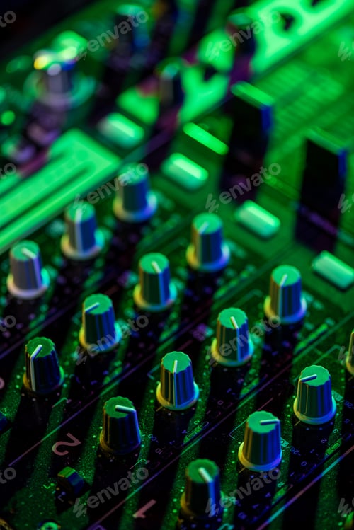 Preview: selective focus of sound mixer in nightclub with green light