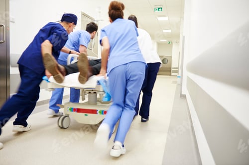 Preview: Rear view of doctors running for the surgery