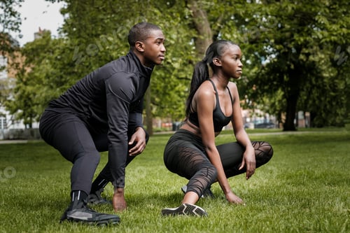 Preview: Black brother and sister twins doing exercise outdoors in stylish sportswear.
