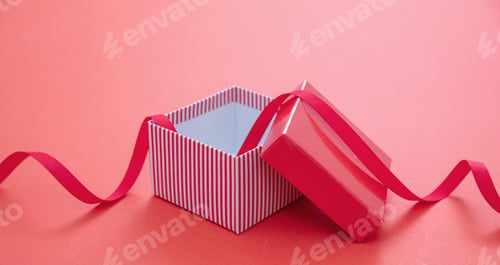 Preview: Christmas present concept. Gift box open and empty on red background.