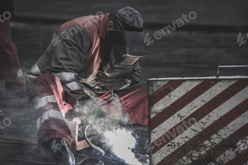 Preview: Selective focus closeup of a male welding iron tracks