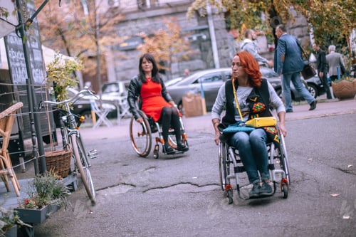 Preview: Two girls in wheelchairs are looking for a cafe accessible for people with disabilities