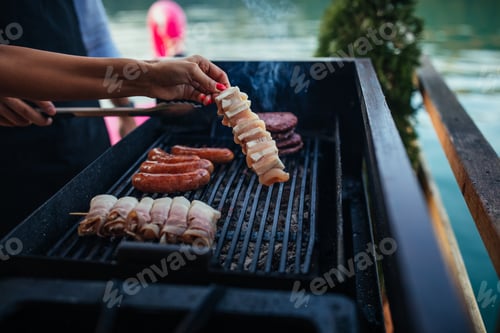 Preview: Female is grilling some delicious ingredient on barbecue outdoors