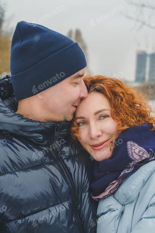 Preview: Affectionate Couple Embrace Outdoors in Winter Attire