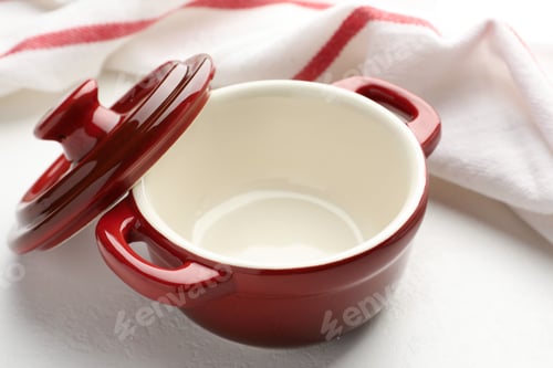 Preview: Ceramic casserole and lid on white table, closeup