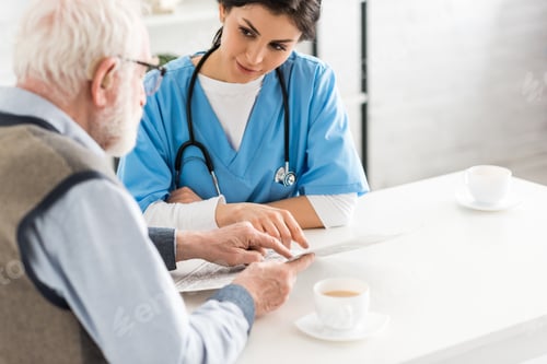 Preview: Cropped view of nurse looking at senior man with newspaper in hands