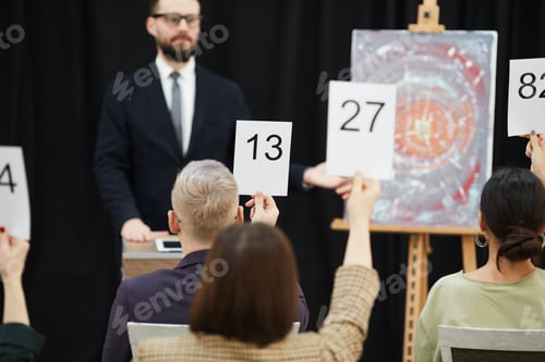 Preview: Group of business people sitting at auction