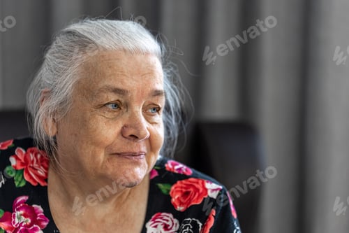 Preview: Close up portrait of an elderly woman at home.