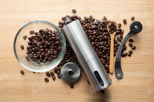 Preview: coffee beans with hand coffee grinders bowl and wooden kitchen spoon on table background