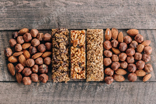 Preview: Health Bars and Mixed Nuts. Energy bars with almond and hazelnuts. Snack for healthy still life.