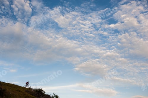 Preview: Silhouette of a cross country cyclist going downhill