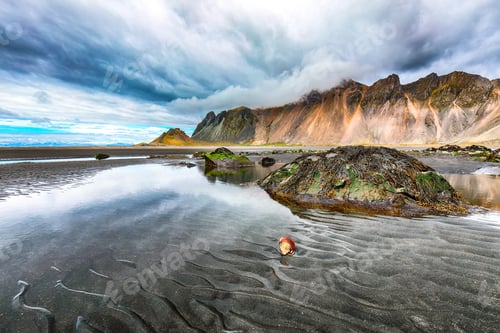 Preview: Dramatic sunny day and gorgeous rippled black sand beach on Stokksnes cape in Iceland.