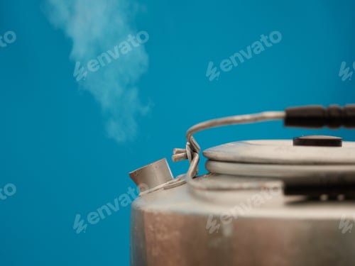 Preview: The steam from a kettle with hot water coming out of it