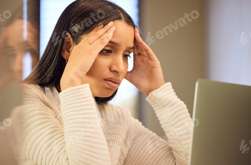 Preview: Cropped shot of an attractive young woman looking stressed while studying at home