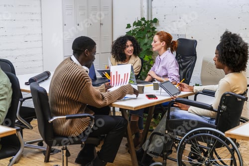 Preview: Diverse business team collaborating on project in coworking space