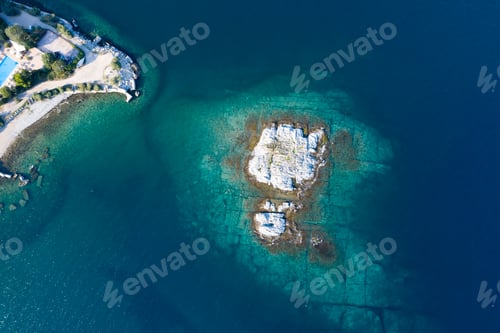 Preview: Aerial drone view of a remote rocky island in open sea.
