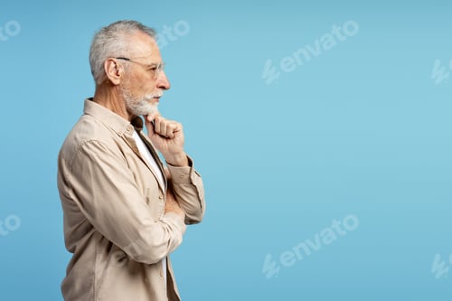 Preview: Pensive senior professor thinking with hand on chin on blue background