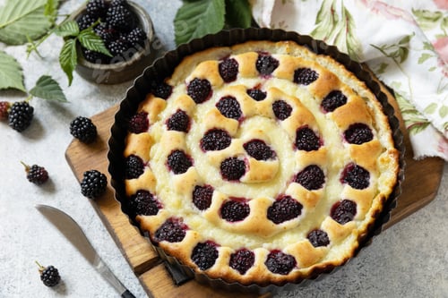 Preview: Homemade blackberry pie. Sweet pie with blackberry and custard on stone tabletop.