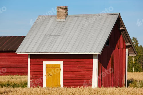 Preview: Traditional finnish red wooden farm in the countryside. Finland