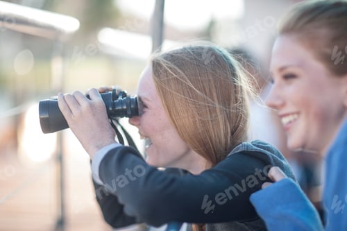 Preview: Girl looking through binoculars on tourist boat trip, Cape Town, South Africa