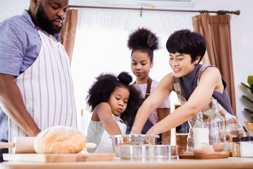 Preview: African American family help prepare the flour for making cookies