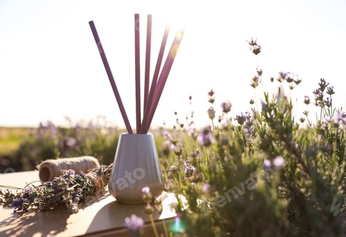 Preview: Reed air freshener on wooden table in blooming lavender field