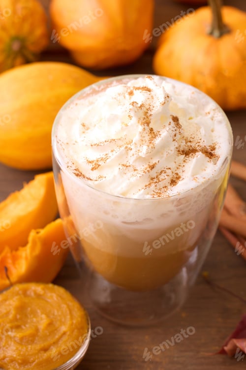 Preview: Pumpkin Spice Latte. A cozy pumpkin spice latte with whipped cream, surrounded by pumpkins