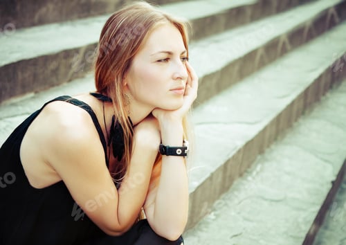 Preview: Portrait of the beautiful blond woman on the stairs