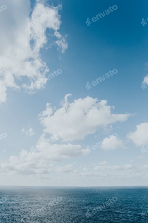 Preview: Crystal clear horizon of the ocean with white clouds with copy space, inspiration and freedom