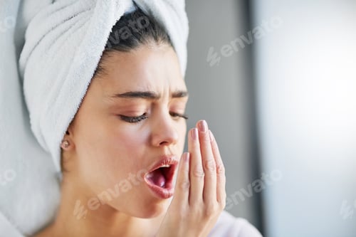 Preview: Check up on your oral hygiene. Shot of a beautiful young woman checking her breath at home.