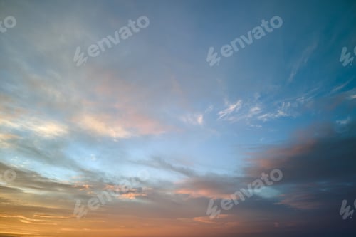 Preview: Bright colorful sunset sky with vivid smooth clouds illuminated with setting sun light spreading to