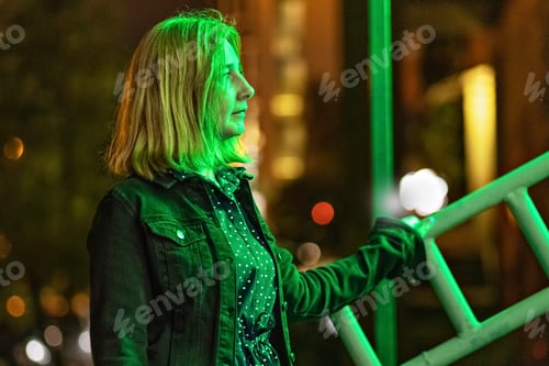 Preview: Portrait of a young woman against the background of night lights. Neon light