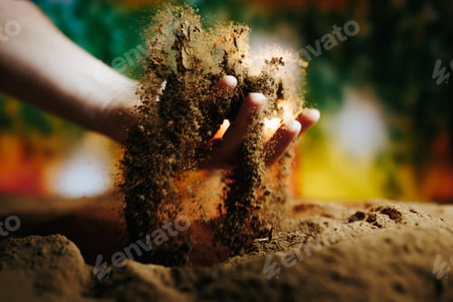 Preview: Hands digging into soil while playing with earth under colorful background