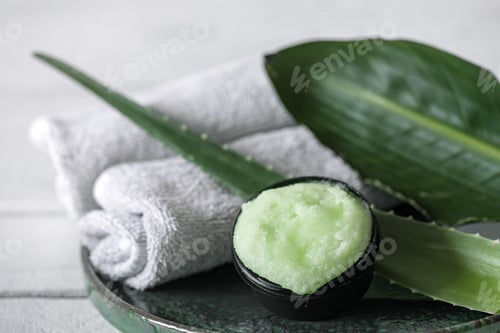 Preview: Spa composition with a natural care product with aloe and towels close up.