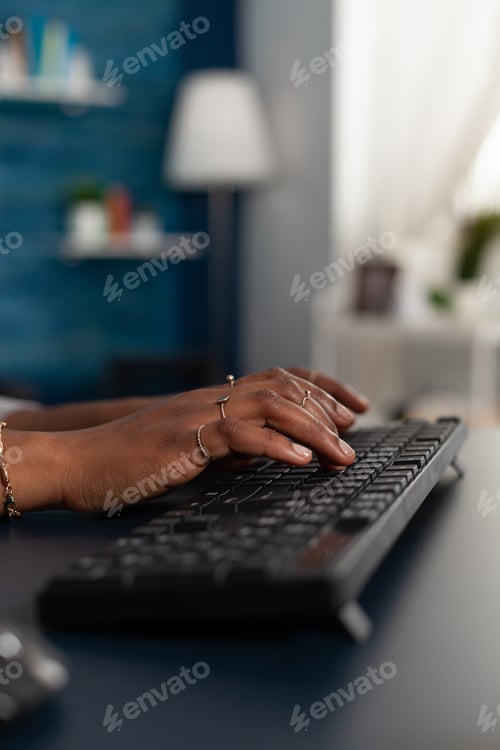 Preview: Closeup of black student hands typing education information on keyboard