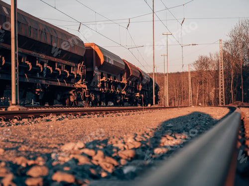 Preview: Cargo train on railways at sunset
