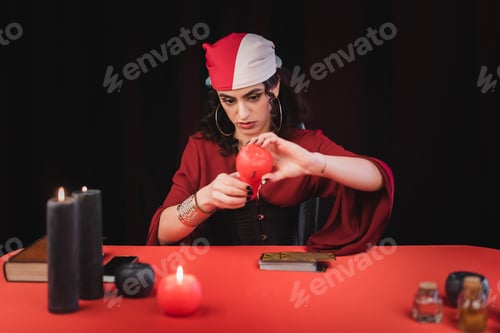 Preview: Gypsy medium burning candles near tarot cards isolated on black