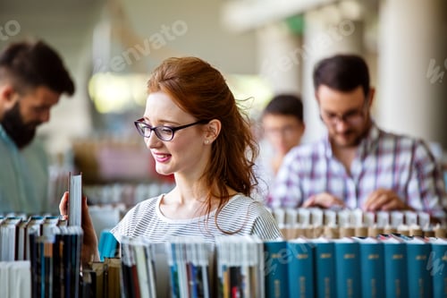 Preview: Happy university students studying with books in library. Group of multiracial people in college