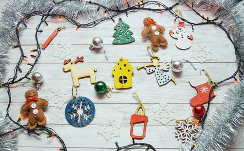 Preview: Christmas ornaments and garland lights on wooden white backgroun