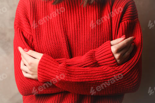 Preview: Young woman in warm red sweater, closeup. Space for text