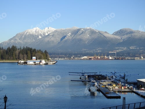 Preview: Numerous floatplanes floating on a serene body of water