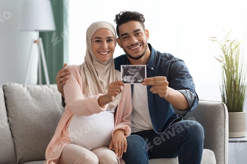 Preview: Pregnant Islamic Lady And Her Husband Showing Baby Sonogram Picture At Camera