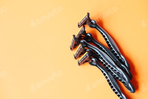 Preview: black color Razor on gray background close up.