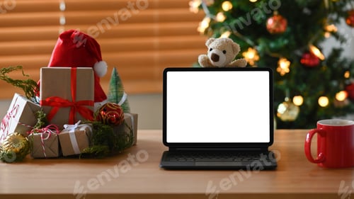 Preview: Digital tablet, cup of coffee and Christmas presents on wooden table.