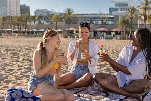 Preview: Friends Enjoying Refreshing Drinks at the Beach