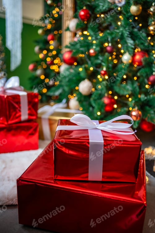 Preview: Gifts under Christmas tree with red, gold and silver toys. Festively decorated Christmas tree with