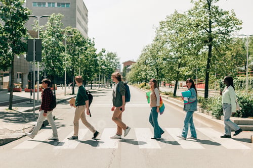 Preview: students in single file cross the street on pedestrian crossings as in abbey road
