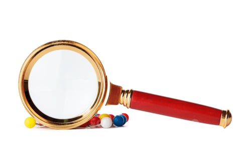 Preview: Magnifying glass looking at closeup of push pin tacks